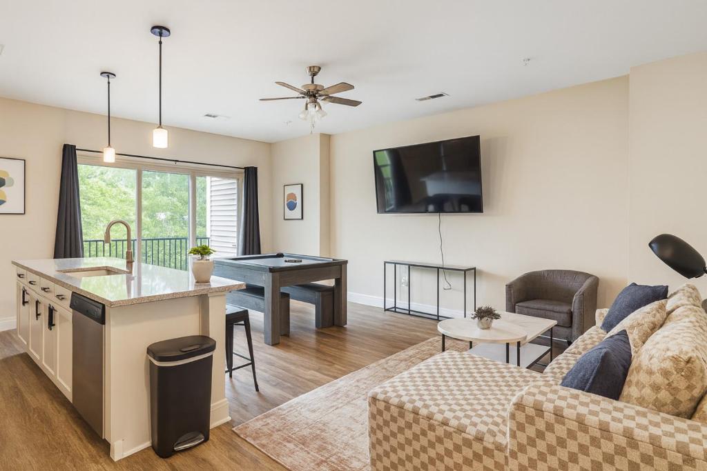 a living room with a couch and a table at Family Group Retreat 3 Queens Pool Table 4th in Homewood