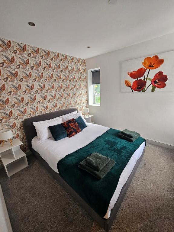 a bedroom with a large bed with a painting on the wall at Cardiff central in Cardiff