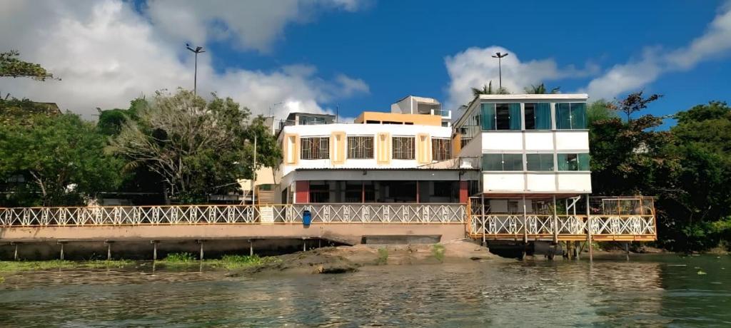 a building on a bridge over a body of water at Pousada Palladium in Neópolis
