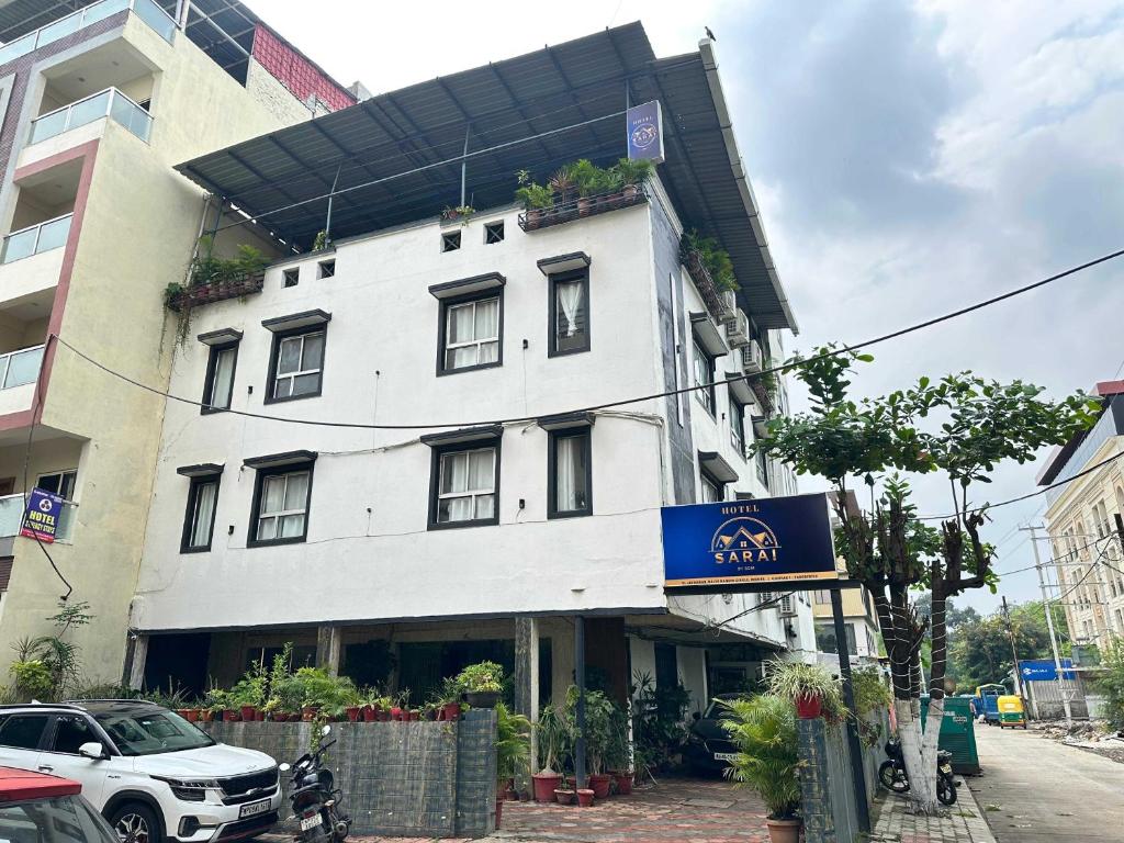 un edificio bianco con un cartello davanti di Hotel O Sarai by Som a Indore