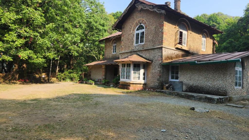 an old brick house with a large yard at Raj Kot in Nainital