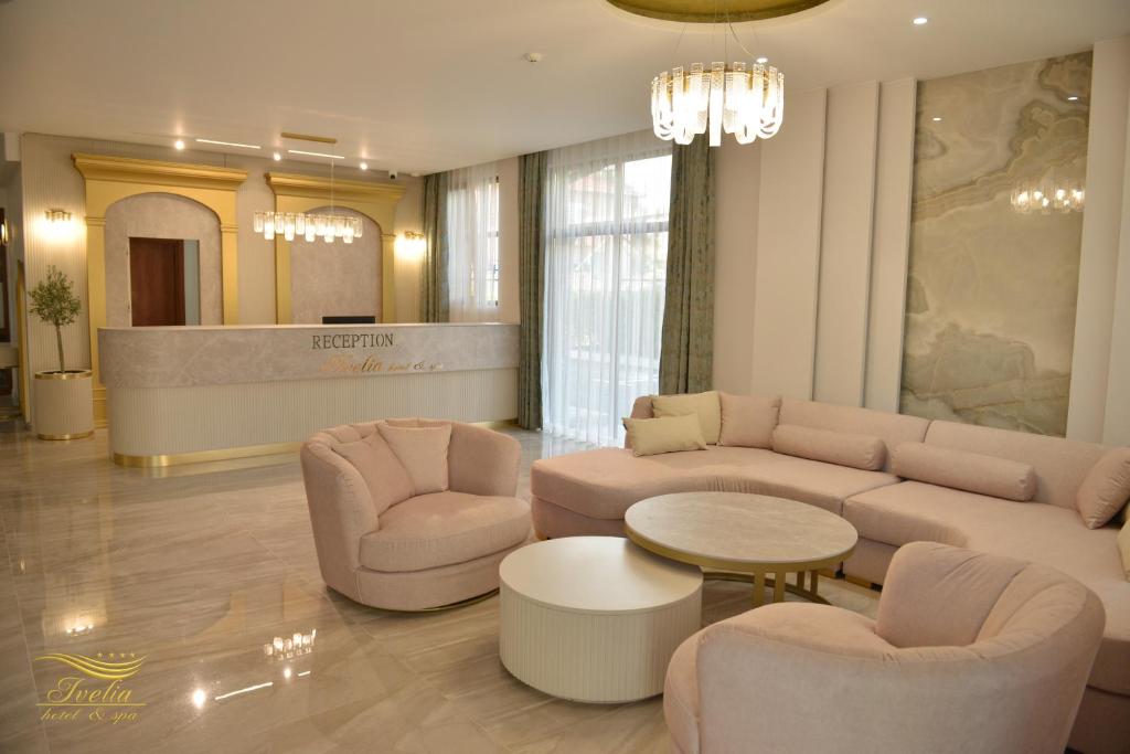 a living room with a couch and chairs and a table at Ивелия Хотел и Спа - Ivelia Hotel & SPA in Dŭbnitsa