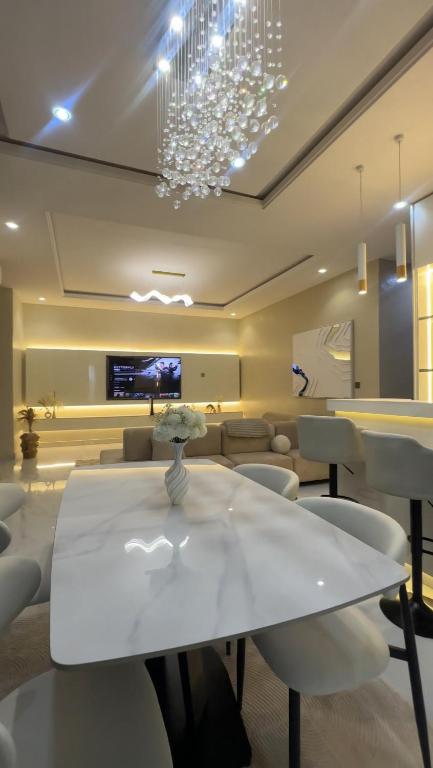 a dining room with a white table and chairs at The Ivory Luxe Suit Lekki phase 1 Lagos in Lagos