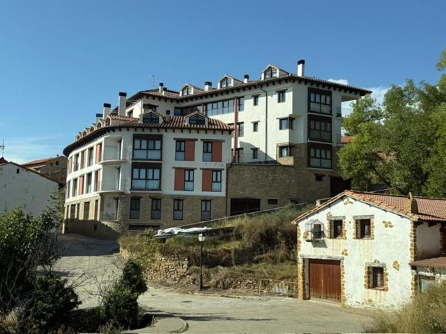 a large white building on top of a hill at el mirador de ona in Valdelinares