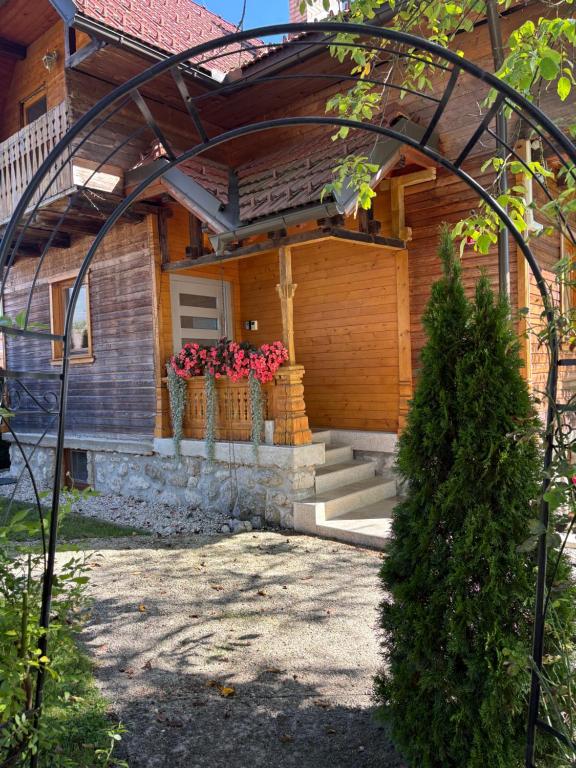 a house with two flower pots on the front of it at Apartments Nina in Bled