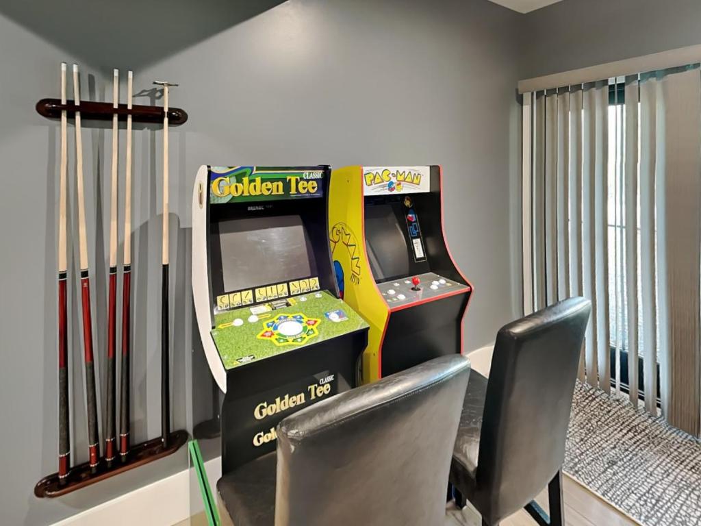 a room with a video game console and two chairs at No Black Tie Affair in McHenry