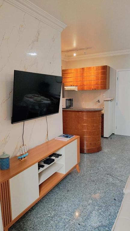 a kitchen with a tv on the wall at Flat Mar Premium 1408 in Fortaleza