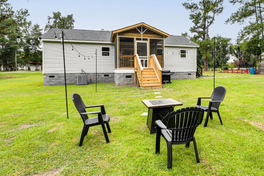a group of chairs and a table and a house at Dog Friendly, Screened Porch St Stephen Retreat! in Saint Stephen