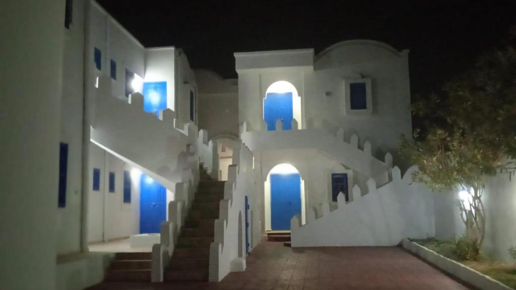 a hallway of a building at night with blue lights at Jamila 3 in Midoun