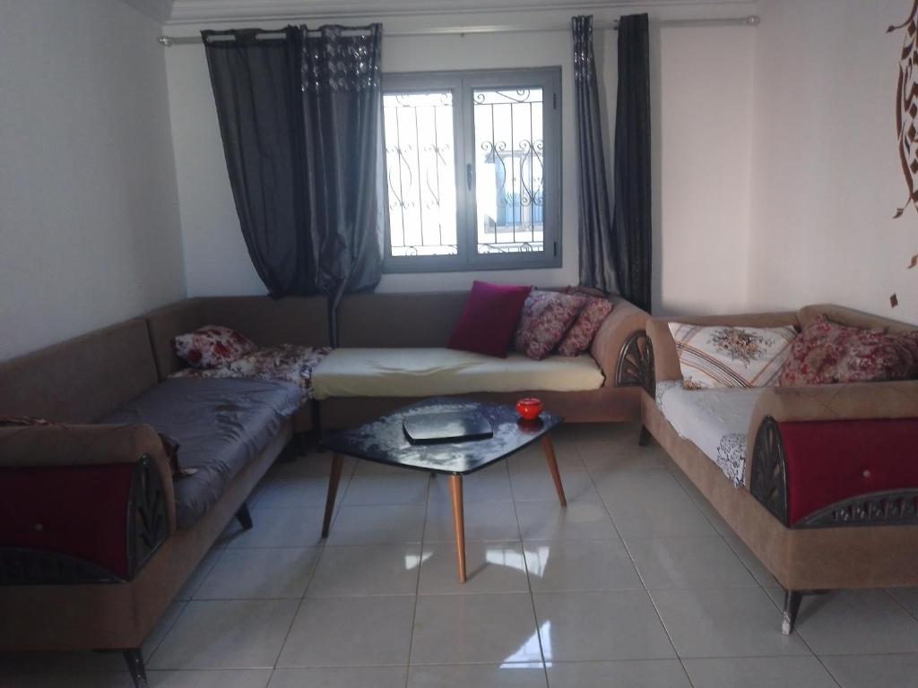 a living room with a couch and a table at Christiana 7 Midoun in Midoun