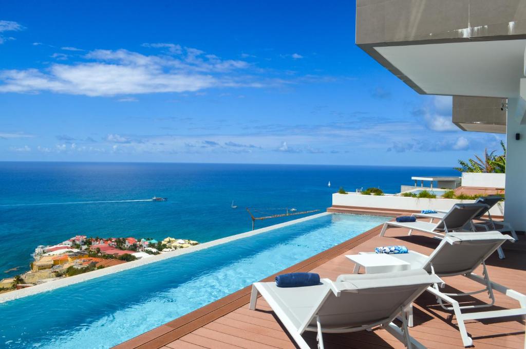 a swimming pool with a view of the ocean at New Condo Eternal Sea - 3 Bedrooms in Koolbaai