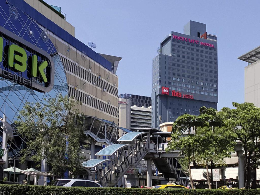 a city with tall buildings and a bridge with cars at ibis Bangkok Siam in Bangkok