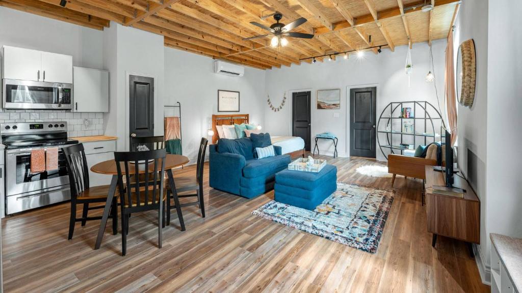 a living room with a blue couch and a table at Charming & Spacious Hideaway by Downtown Bryan in Bryan