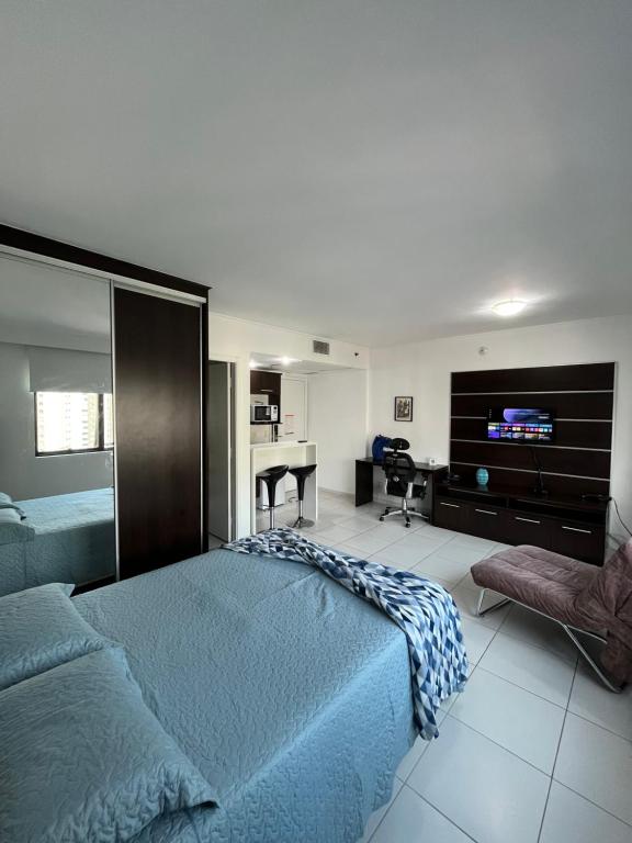 a bedroom with a bed and a desk and a television at Hotel Moema Shopping Ibirapuera Com Garagem 1420 in Sao Paulo
