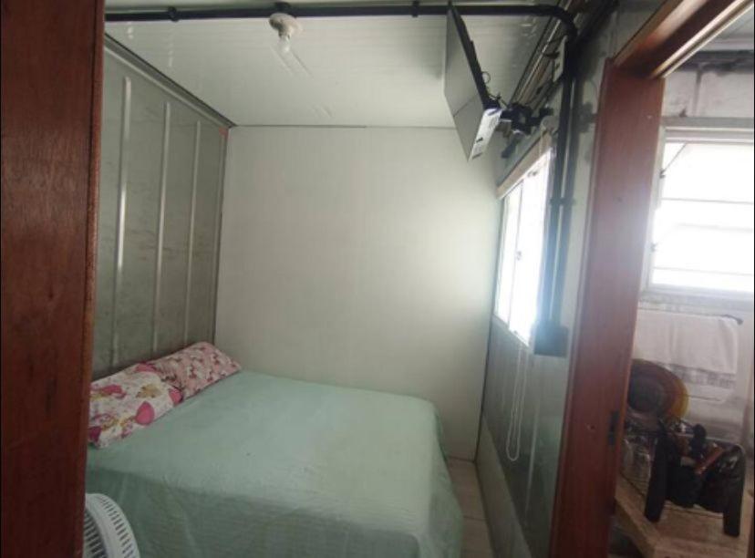 a small room with a bed and a window at Vila do Chaves Bruxa do 71 in Itajaí