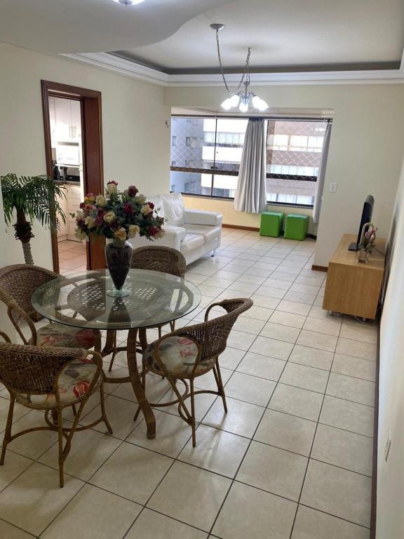 a living room with a glass table and chairs at Apto CAPAO DA CANOA Ed GABRIELA 6 Pers in Capão da Canoa