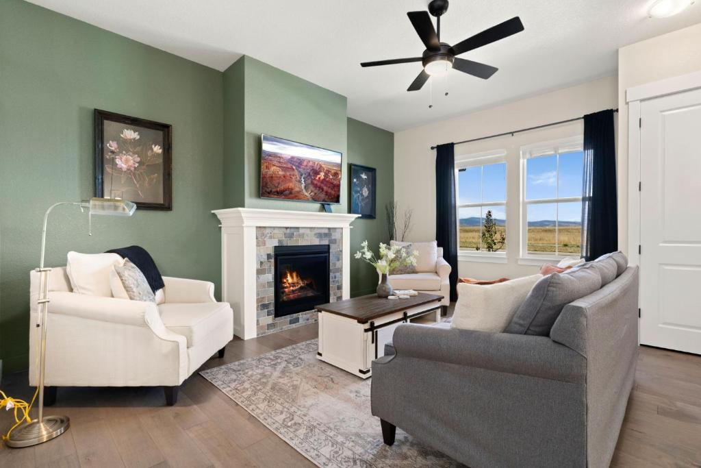 a living room with two chairs and a fireplace at Scenic Mountain Retreat Golf, Pickleball, Relax in Loveland