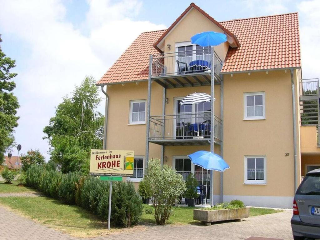a house with two blue umbrellas in front of it at Holiday apartment in Ramsberg