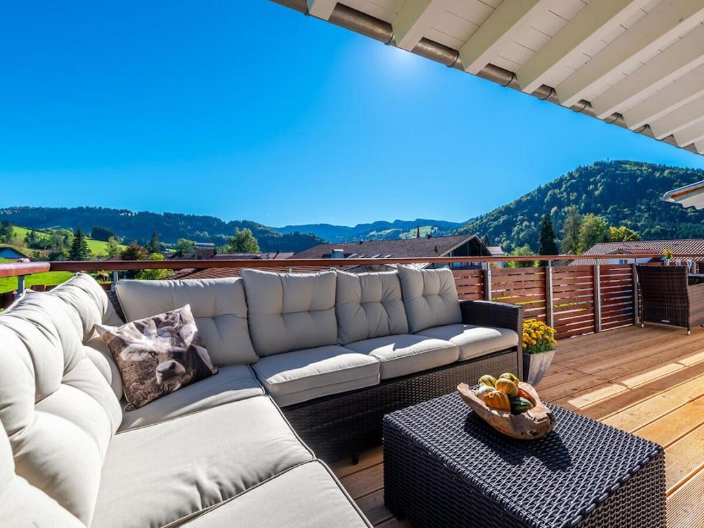 a living room with a couch on a deck at One-bedroom apartment in Kalzhofen