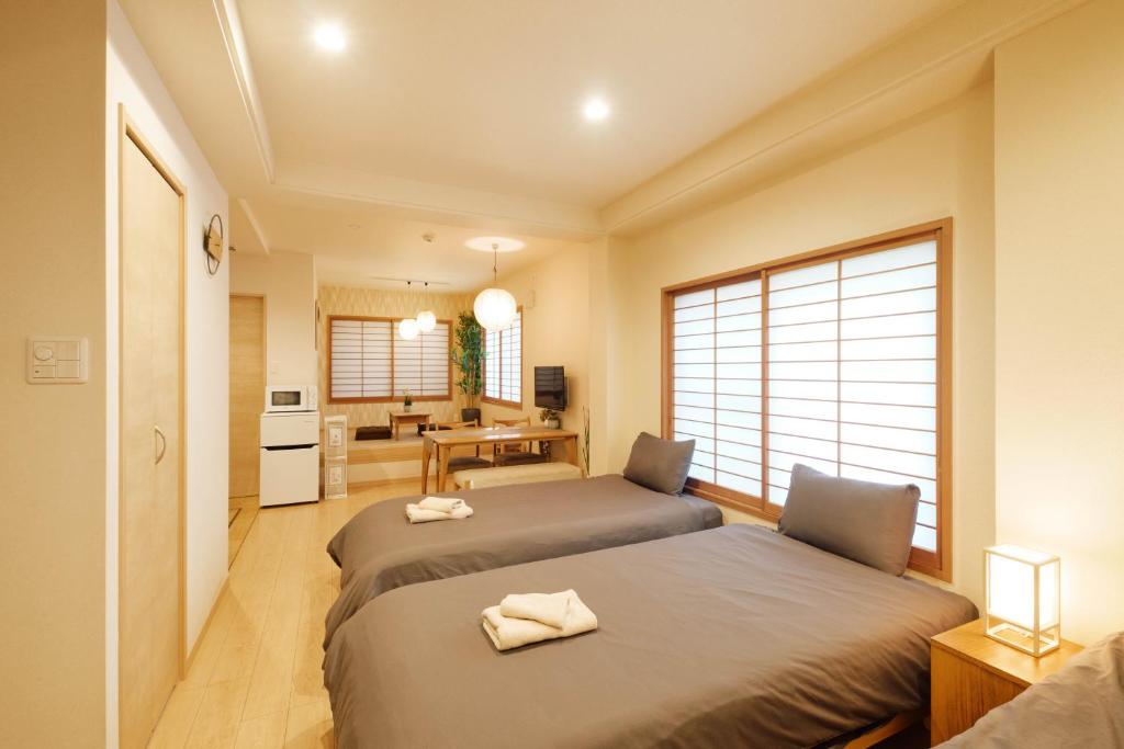 Katil atau katil-katil dalam bilik di Ueno Residence Hotel Matsumoto