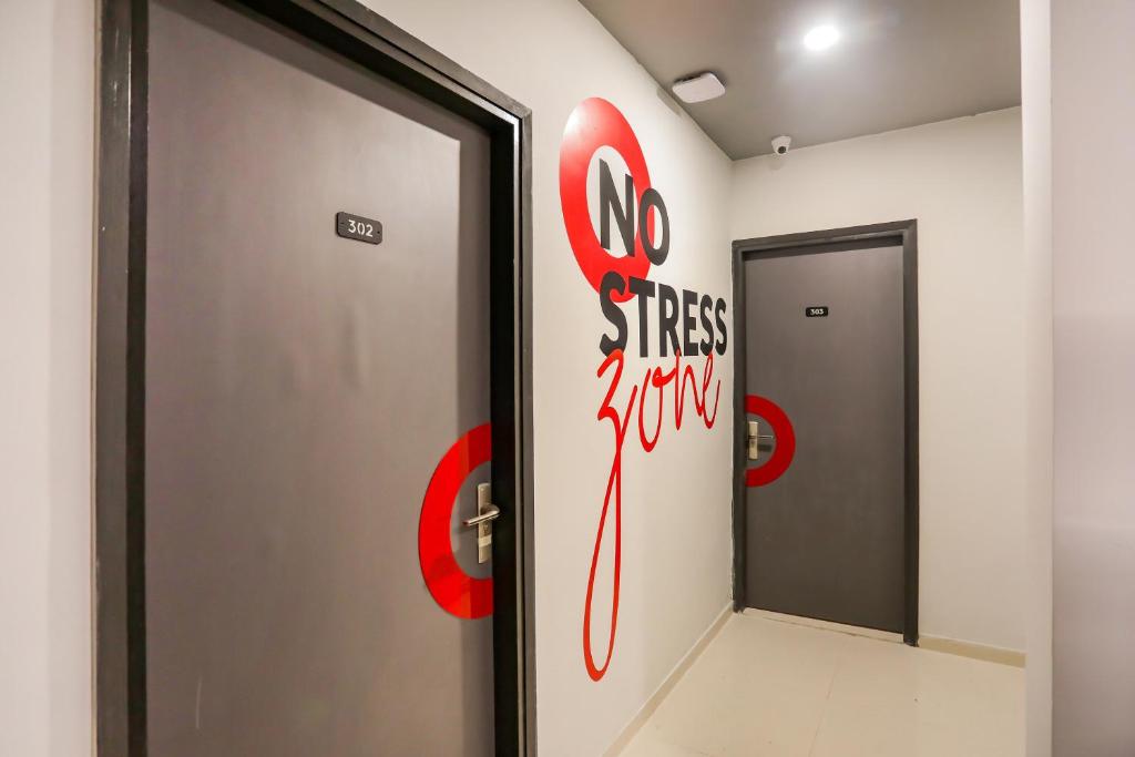 a corridor with a door with a no stress jumping sign at Collection O Le Noida Hotel Near Sector 76 Metro Station in Noida