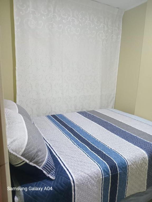 Una cama o camas en una habitación de Hospedaje TITANIC