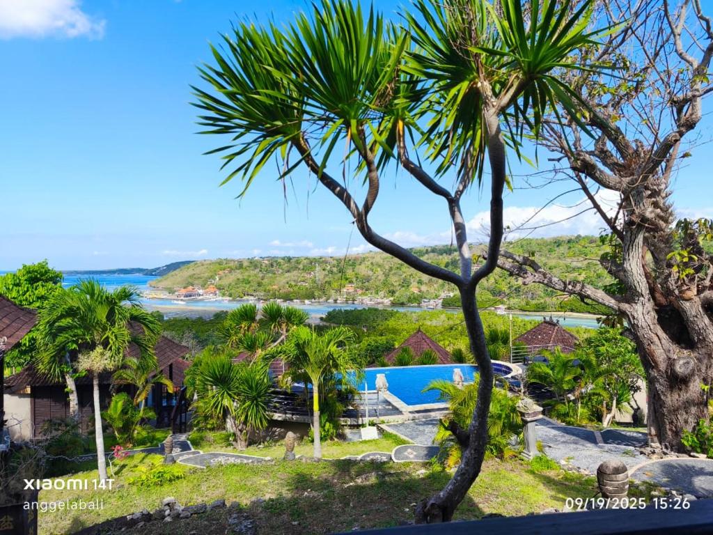 una vista dell'oceano da un resort con palme di Sunrise Cottage Lembongan a Nusa Lembongan