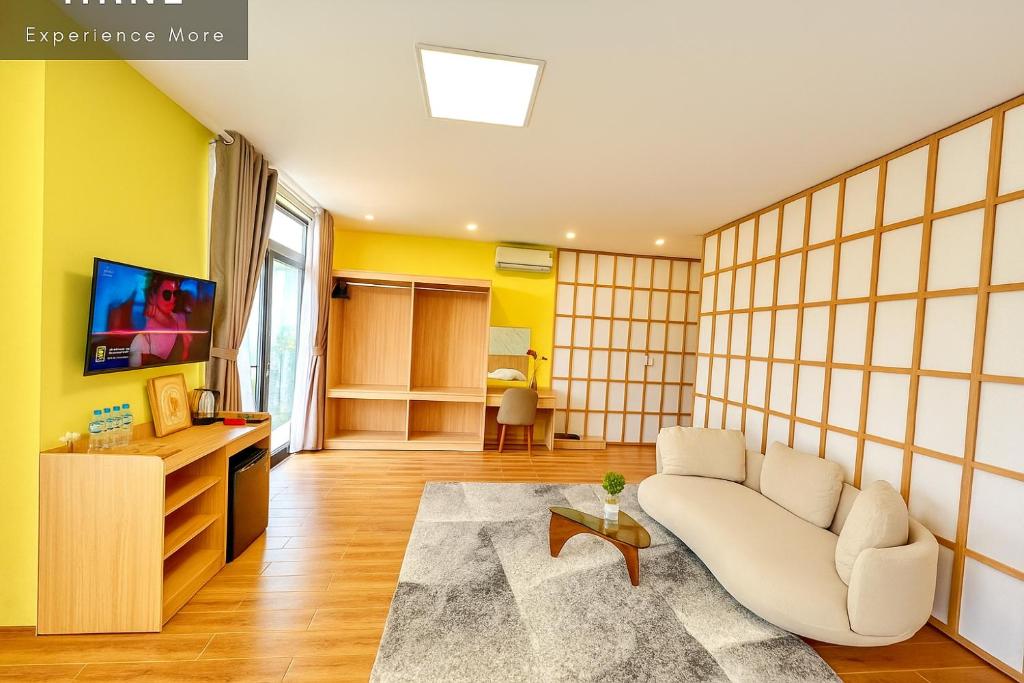 a living room with a couch and a tv at S79 PowerMia RiverFront Grand World in Phu Quoc