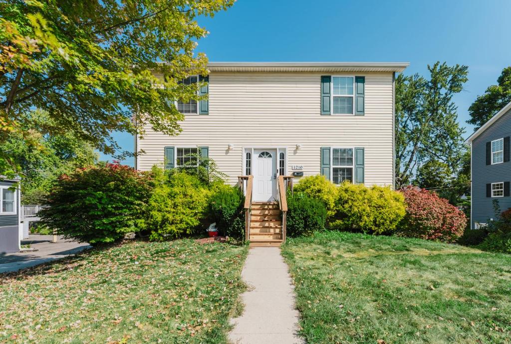 a house with a pathway leading to the front door at Modern Renovated 3-Bed Near Ann Arbor & Ypsilanti in Ypsilanti