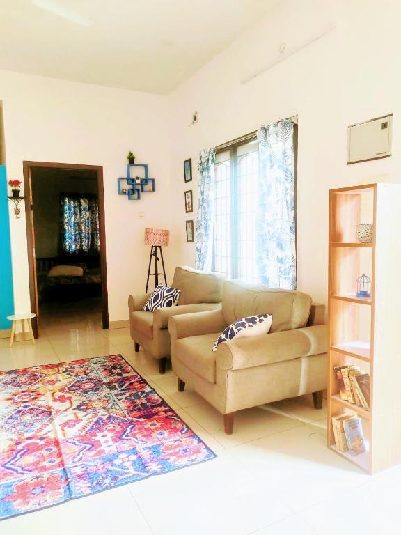 a living room with two couches and a rug at DREAMY cosy stay 4bhk, 6 mins to Whitetown & Beach - COPPER in Puducherry