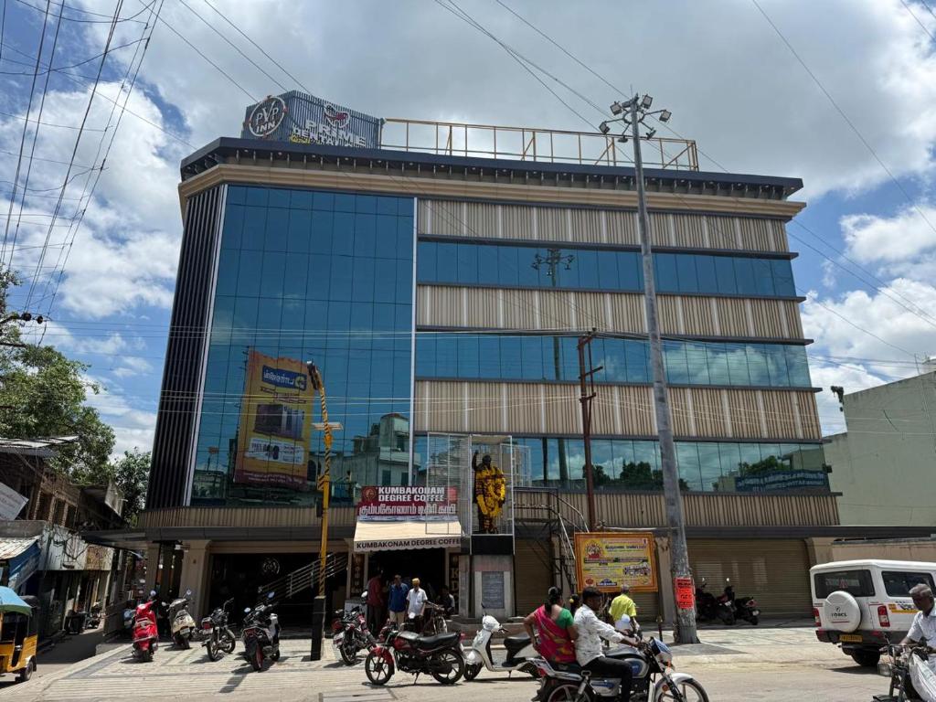 a large building with people on motorcycles in front of it at pvp inn in Ārani