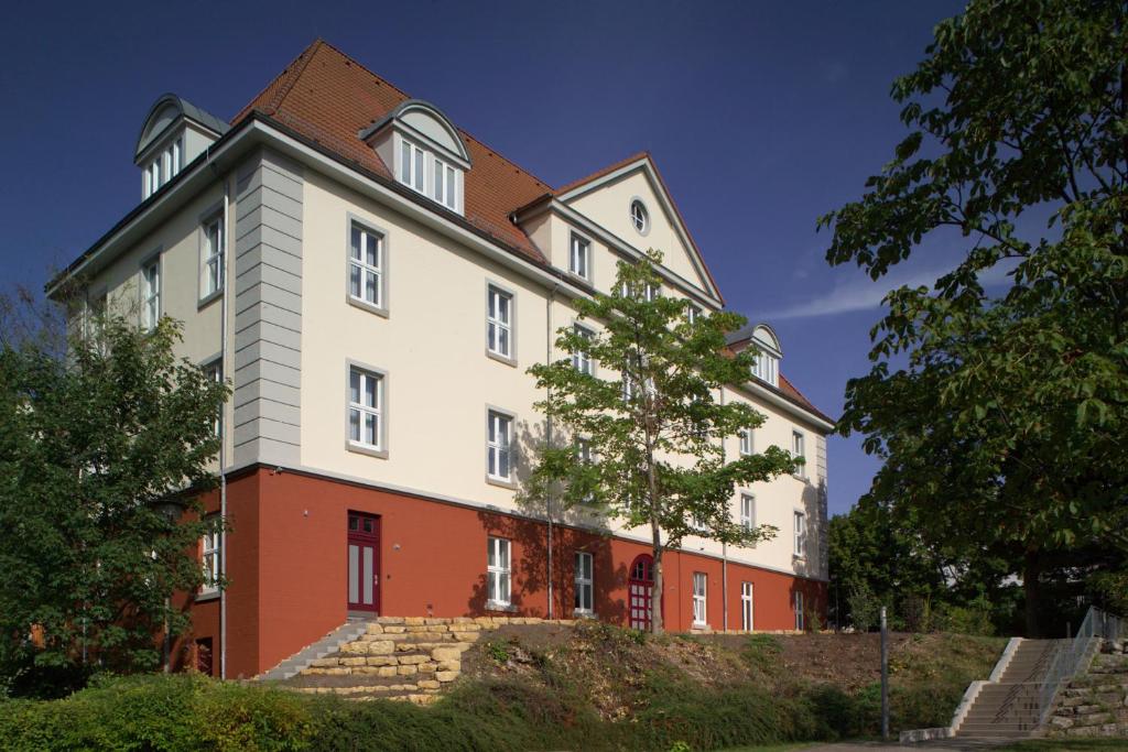 a large white building with a clock on it at Hotel Brühlerhöhe in Erfurt