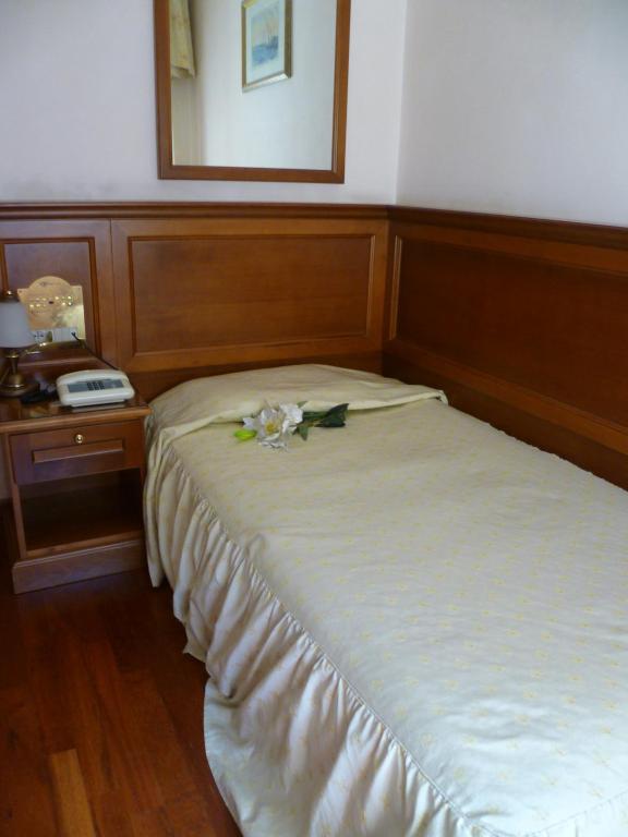 Postel nebo postele na pokoji v ubytování Hotel Minerva