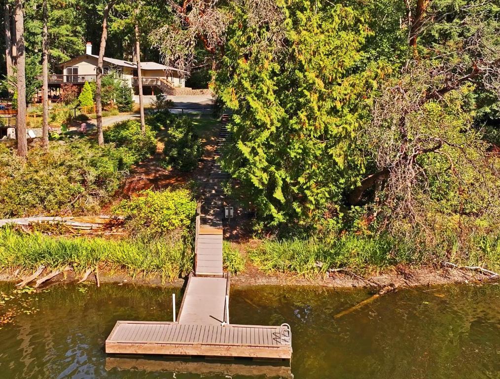 a dock in the middle of a body of water at Lake House - Anderson Island in Anderson Island