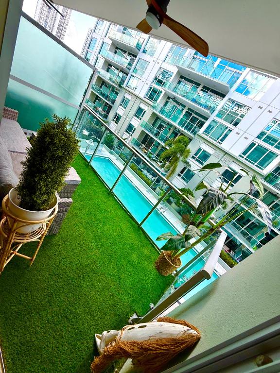 a view of a building with a pool and plants at Channelside Luxury Retreat Spacious 2BR 2BA Condo with Pool, Balcony, Sauna & Gym in Tampa