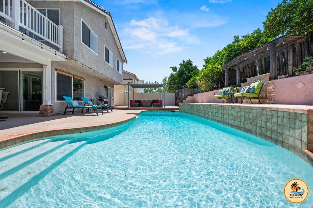 a swimming pool in the backyard of a house at Cozy Tierrasanta Escape-4BR, Pool, Firepit, Games! in San Diego