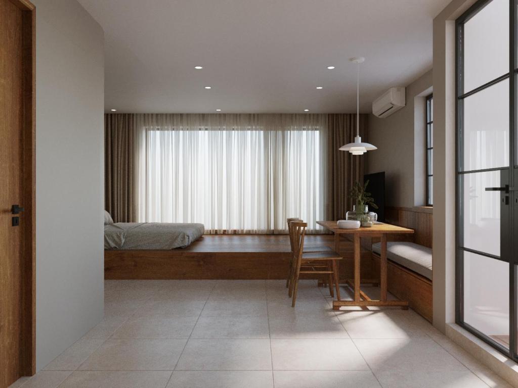 a bedroom with a bed and a table and a dining room at The Jade Phoenix Hanoi-Cozy Retreat with Private Balcony-Free Laundry in Hanoi