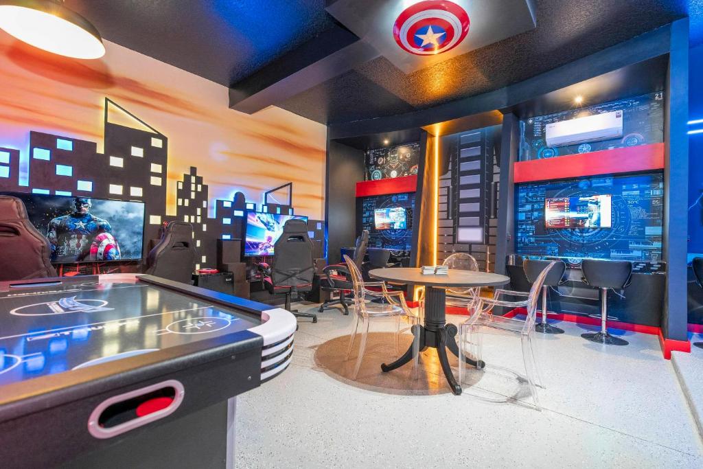 Habitación con mesa de ping pong y videojuego en Luxury 12BR Home w Pool Theater Game Room, en Kissimmee