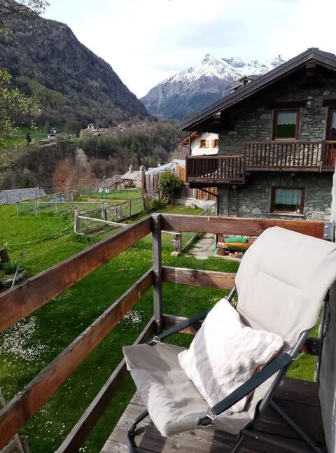 a chair on a balcony with a view of a mountain at Casa Indipendente Val d'Ayas - Challand Saint Anselme in Challand Saint Anselme