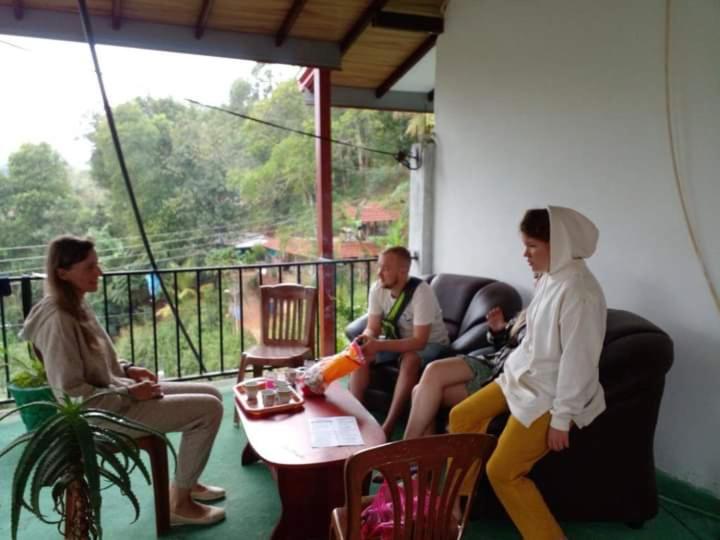 a group of people sitting on a porch at Mountain Top Guest in Bandarawela