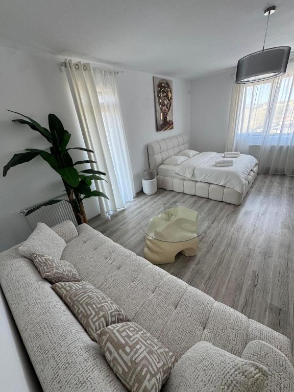 a living room with two beds and a couch at Daly Residence in Buzău