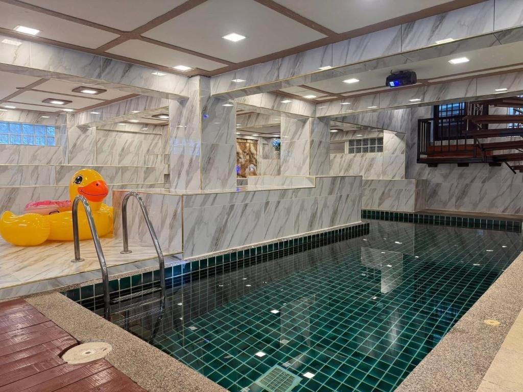 a swimming pool with a rubber duck in the middle at Cheeva Pool Villa Phuket in Phuket