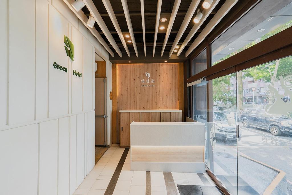 a lobby of a store with a bench and a door at Green Hotel - Fengjia in Taichung