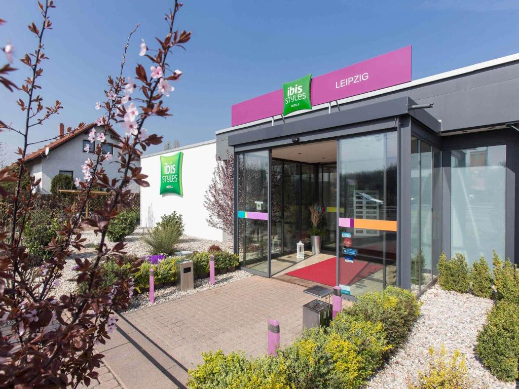 a building with a sign on the side of it at ibis Styles Leipzig in Radefeld