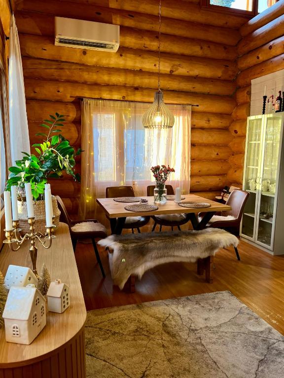 a dining room with a table in a log cabin at River's Whisper Cottage in Rovaniemi