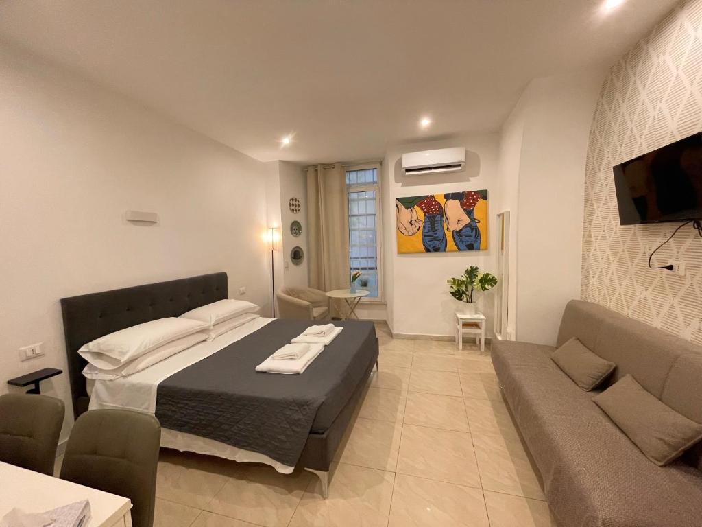 a bedroom with a large bed and a couch at THE ROOM 115 in Rome