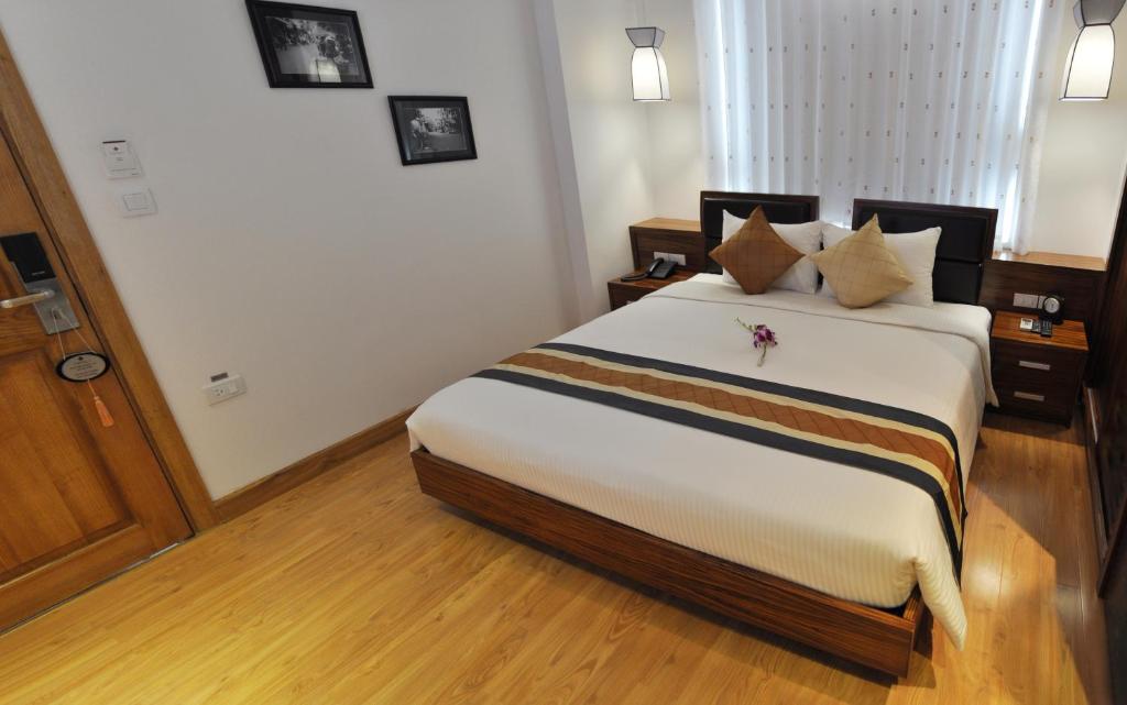 Postel nebo postele na pokoji v ubytování Elite Central Hotel Hanoi