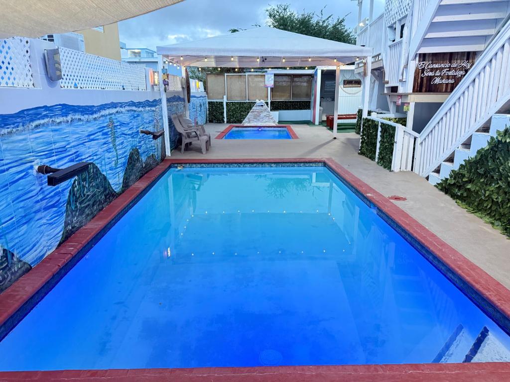 a swimming pool with blue water in a house at Cabana Playa Santa Apto C Piscinas Solar Energy in Guanica