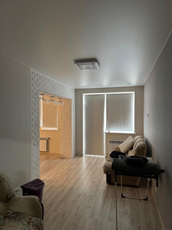 a living room with a couch on a wooden floor at Kachanivska apartments in Kharkiv