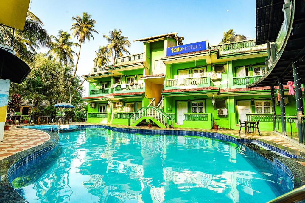 a swimming pool in front of a hotel at Via Jesant Valley Resort - Nr Candolim Beach in Candolim